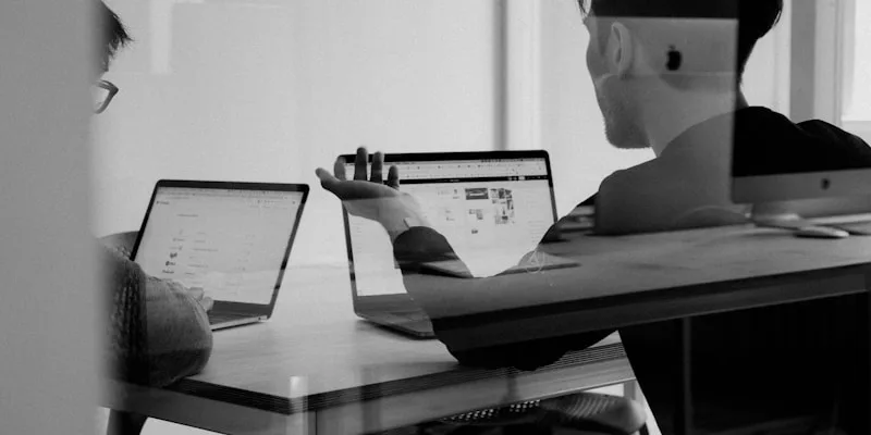 Consultant and client reviewing an IT roadmap across a table