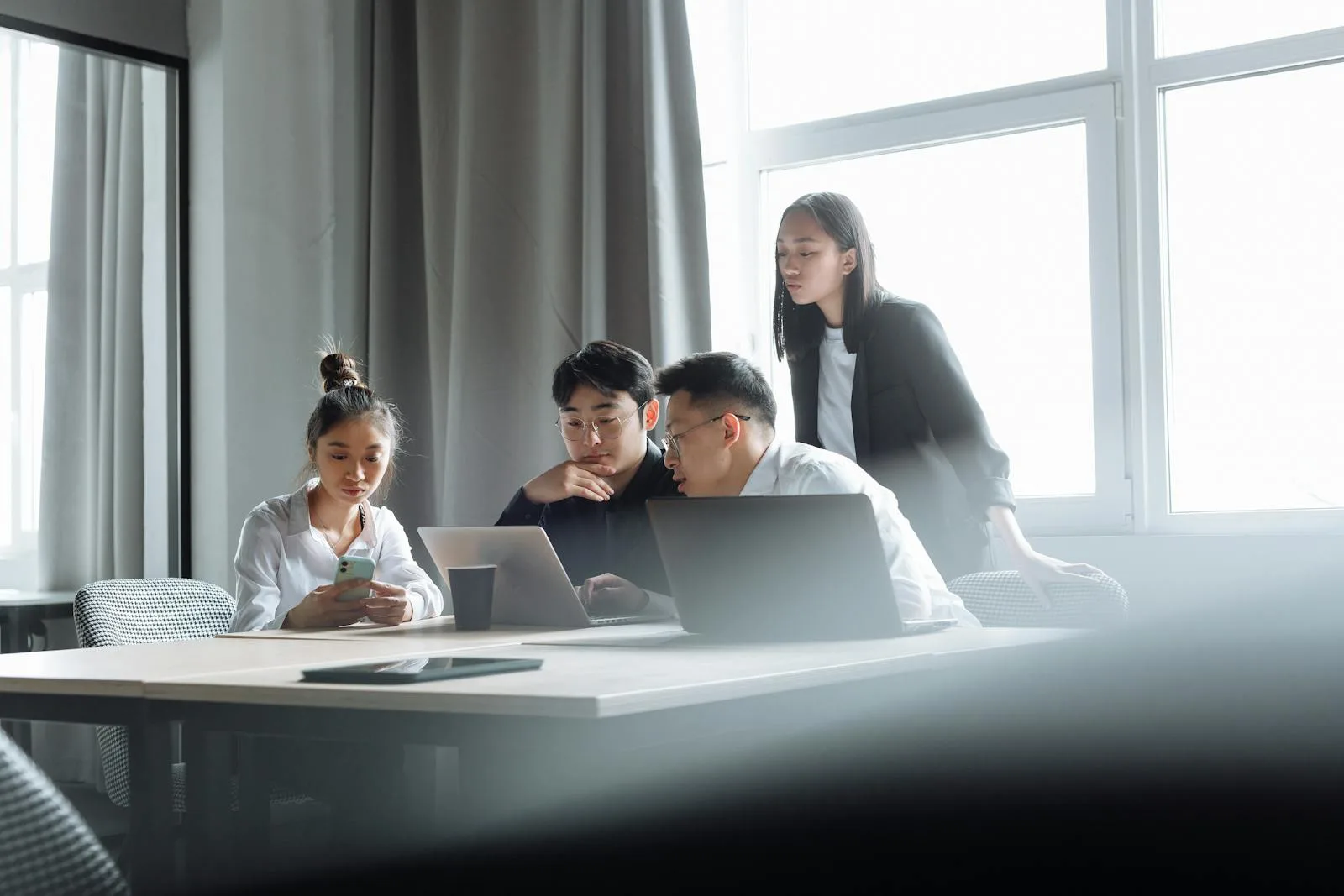 Young business team working on laptops in a modern Dubai office